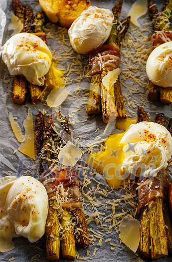 Asparagus in bacon with egg poached, croutons and Parmesan cheese. Top view. Close Up. Asparagus in bacon with egg poached, croutons and Parmesan cheese. Top view. Close Up.