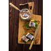 Herring sandwich (traditional Danish smorrebrod) on cutting board. Top view.