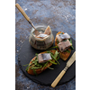 Herring sandwich (traditional Danish smorrebrod) on cutting board.