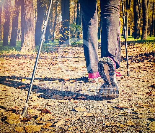 Close up of hinking woman feet and nordic walking poles. Vintage retro effect filtered hipster style image Close up of hinking woman feet and nordic walking poles. Vintage retro effect filtered hipster style image