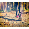 Close up of hinking woman feet and nordic walking poles. Vintage retro effect filtered hipster style image