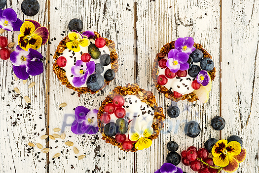 Dessert with sunflower seeds, yogurt and fresh berries on white wooden background Dessert with sunflower seeds, yogurt and fresh berries on white wooden background