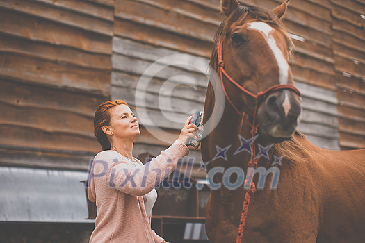 Pretty, young, redhead woman with her lovely horse, during her favorite leisure Pretty, young, redhead woman with her lovely horse, during her favorite leisure