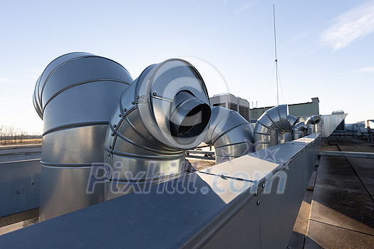 External unit of commercial air conditioning and ventilation system installed on industrial building roof. Exhaust vent on flat factory rooftop External unit of commercial air conditioning and ventilation system installed on industrial building roof. Exhaust vent on flat factory rooftop