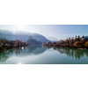Amazing tranquil autumn landscape with smooth water surface of Inn river before beautiful view of Kufstein Fortress and boardwalk along river. Kufstein, Austria.