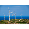 Green renewable alternative energy concept - wind generator turbines generating electricity. Wind farm on Crete island, Greece with small white church