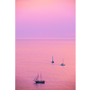 Tourist yachts boat in Aegean sea near Santorini island with tourists watching sunset from viewpoint. Santorini, Greece