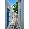 Picturesque scenic narrow Greek streets with traditional whitewashed houses with blue doors windows of Mykonos town in famous tourist attraction Mykonos island, Greece