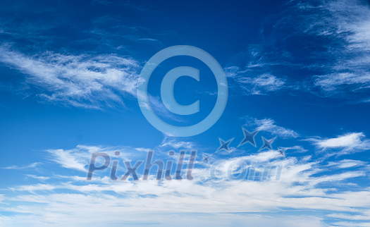 Blue clear sky with white cirrus spindrift clouds background Blue clear sky with white cirrus spindrift clouds background