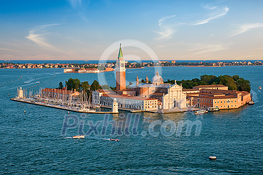 Famous Italy tourist destination - aerial view of Venice lagoon and San Giorgio di Maggiore church with boats and vaporetto traffic on sunset from St Mark's Campanile bell tower, Venice, Italy