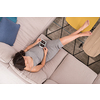 top view of a young pregnant woman looking baby's ultrasound photo while relaxing on sofa at home