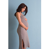Portrait of happy pregnant woman with hands on belly isolated over blue background