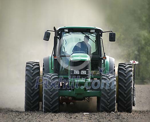 Man driving a tractor on the field Man driving a tractor on the field
