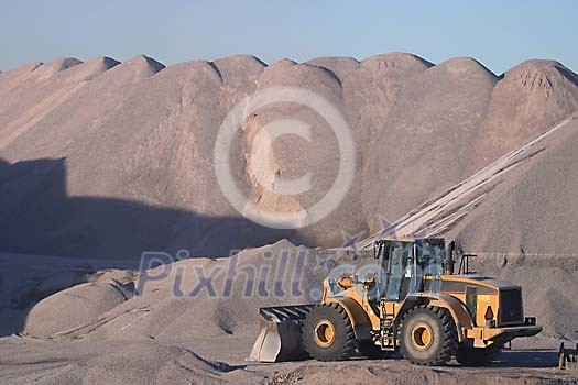 Caterpillar in front of a mountain of sand