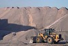 Caterpillar in front of a mountain of sand