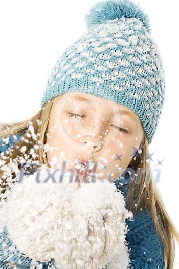 Girl blowing snow from her hands Girl blowing snow from her hands