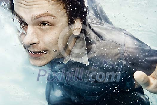 Man swimming in his clothes Man swimming in his clothes