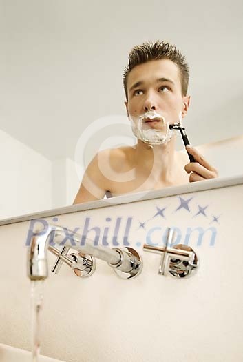Man shaving in the bathroom Man shaving in the bathroom