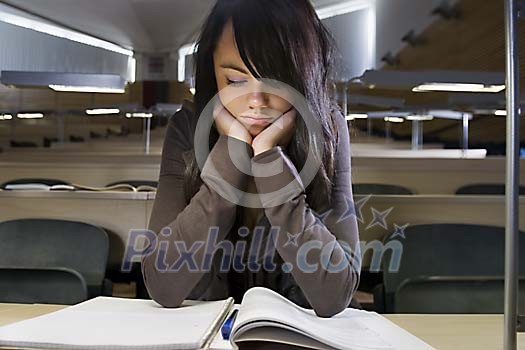 Woman sitting in the classroom and reading Woman sitting in the classroom and reading