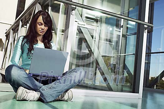 Girl with laptop in the hallway Girl with laptop in the hallway