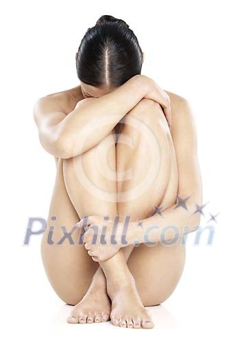 Naked woman sitting on the ground Naked woman sitting on the ground
