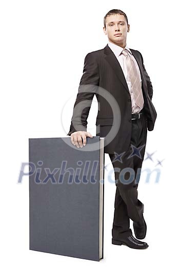 Businessman standing with a big book Businessman standing with a big book