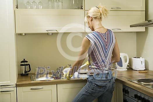 Woman in the kitchen doing the dishes