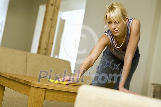 Woman dusting the table Woman dusting the table