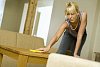 Woman dusting the table