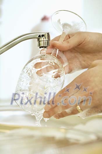 Woman hands wasing a glass Woman hands wasing a glass