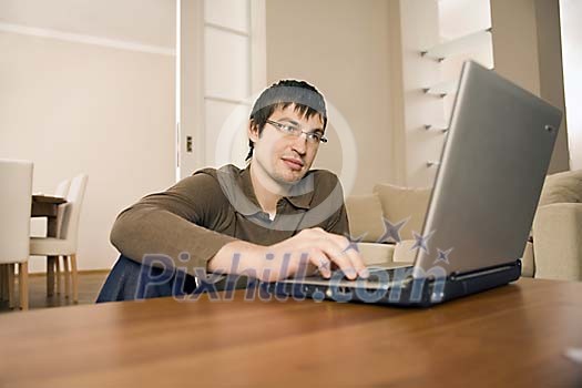 Man with laptop at home Man with laptop at home