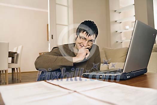 Man in the livingroom with laptop Man in the livingroom with laptop