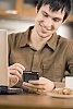 Man sitting on the table looking at his phone