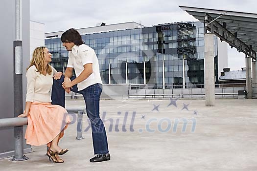 Couple talking on the roof Couple talking on the roof