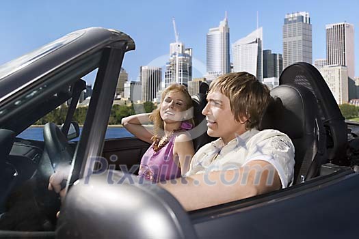 Couple driving in convertible car