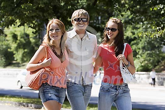 Man walking with two women outside Man walking with two women outside