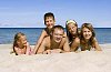 Family lying on the sand 