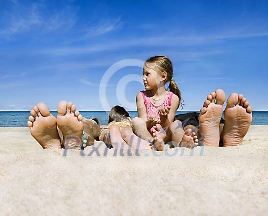 Family getting a suntan Family getting a suntan