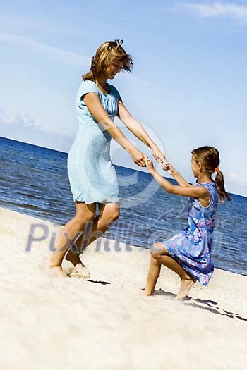 Woman palying with daughter on the beach Woman palying with daughter on the beach