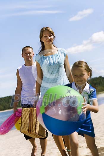 Man and woman with girl on the beach Man and woman with girl on the beach
