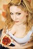 Woman holding a white bread with jam on it
