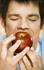 Man taking a bite of apple