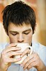 Man looking down to his cup