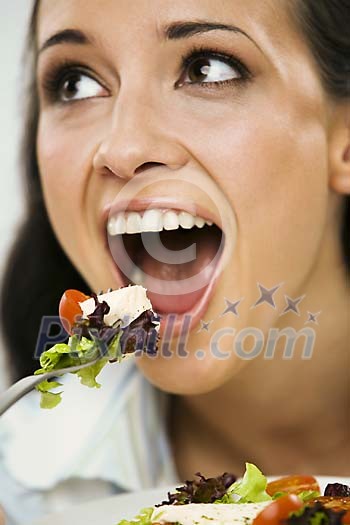 Woman eating salad