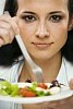 Woman holding a plate of salad