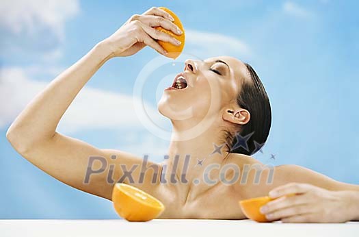 Woman squeezing orange for juice