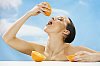 Woman squeezing orange for juice