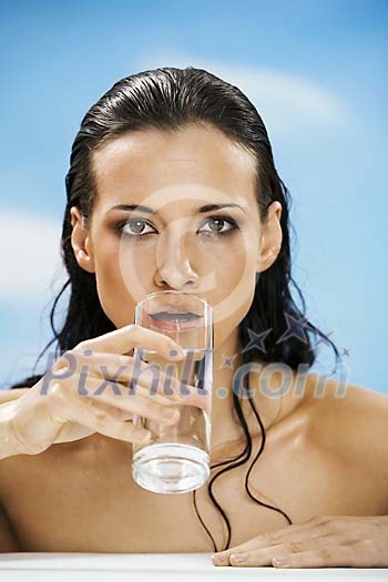 Woman drinking a glass of water Woman drinking a glass of water