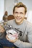 Man eating a bowl of dessert