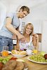 Man pouring coffee for woman